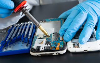 Friendly technician helping a customer with a phone repair in a local repair shop.